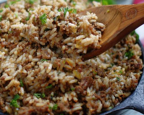 Wooden spoon serving dirty rice