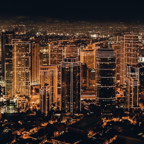 A sprawling city shining with golden light in the night.